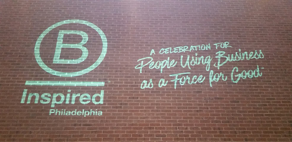 Sign on brick wall from 2016 annual B Corp retreat that reads: "B Inspired Philadelphia. A celebration for people using business as a force for good."